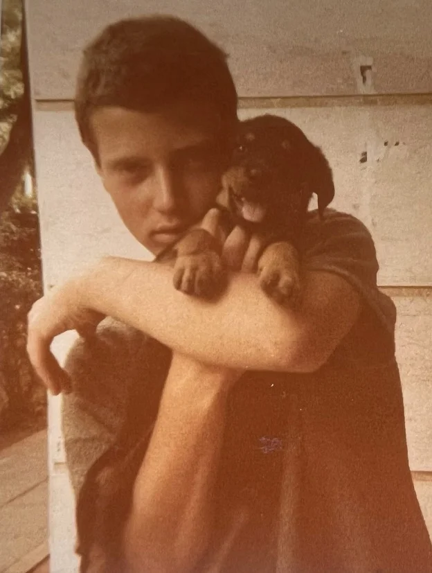 A boy holding a puppy